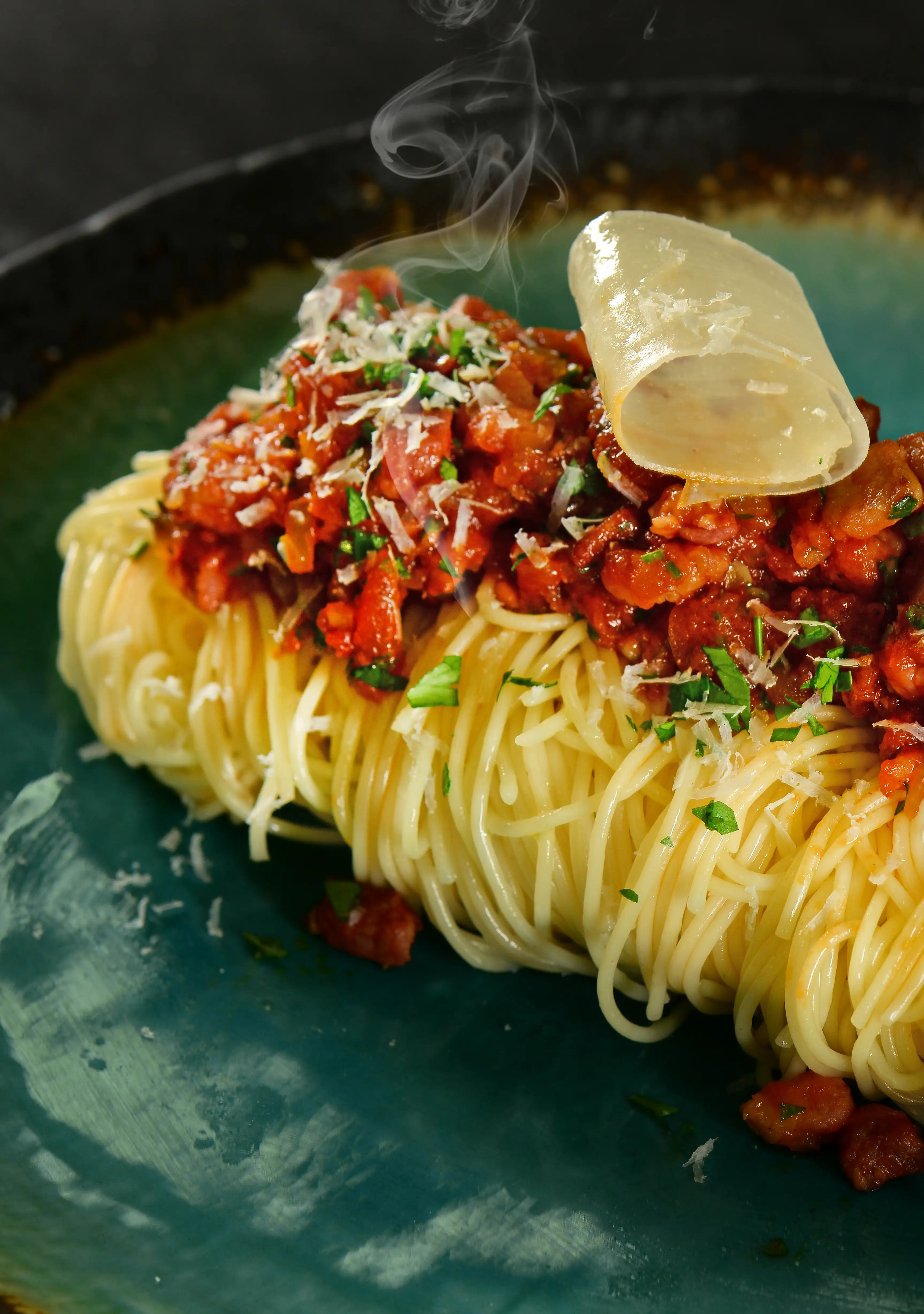 Spaghetti Bolognese nest with parmesan crisp — restaurant photography Dubai