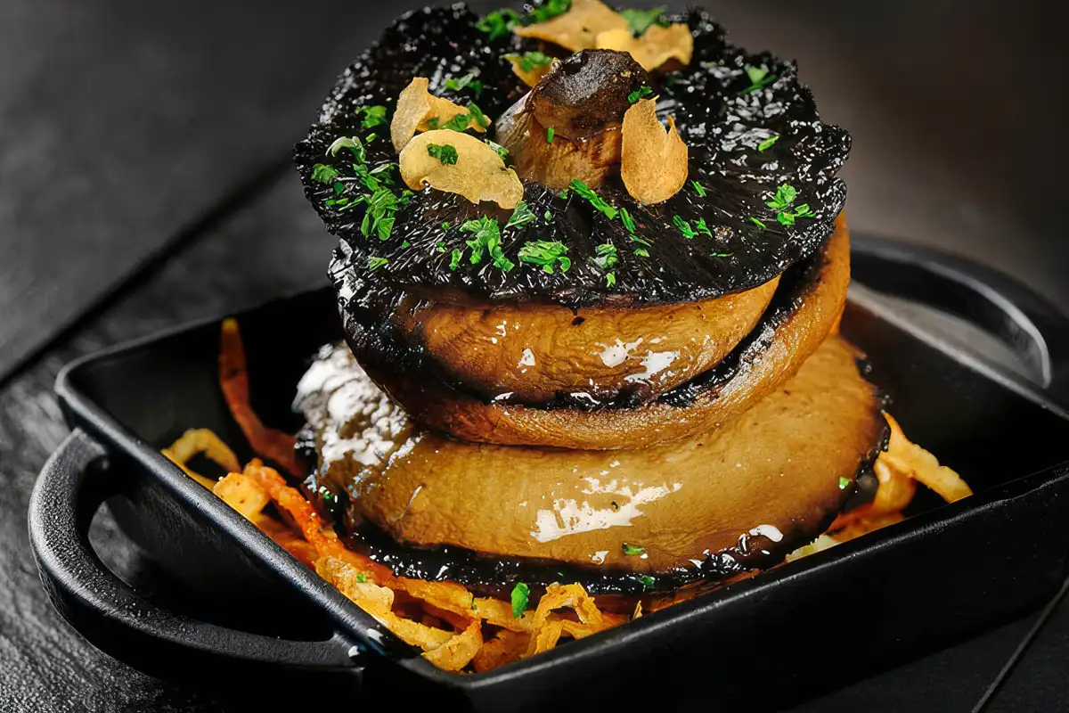 Grilled portobello mushroom stack with crispy onions — restaurant photography Dubai