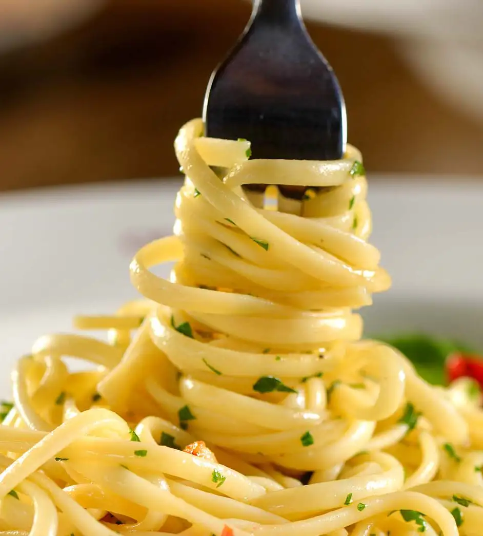 Linguine pasta twirled on fork — hotel food photography Dubai