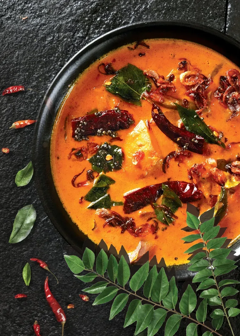 Kerala style fish curry with curry leaves and dried chillies — professional food photographer Dubai