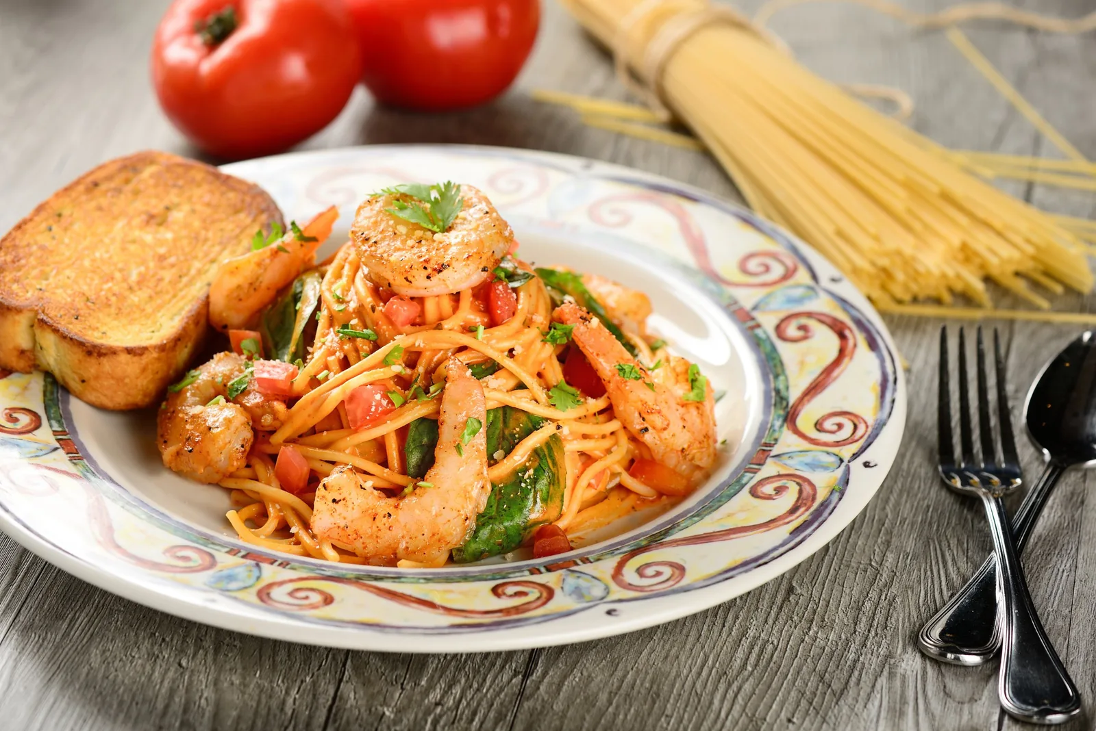 Spaghetti with grilled shrimp, basil and tomato served with garlic toast — food photographer in Dubai