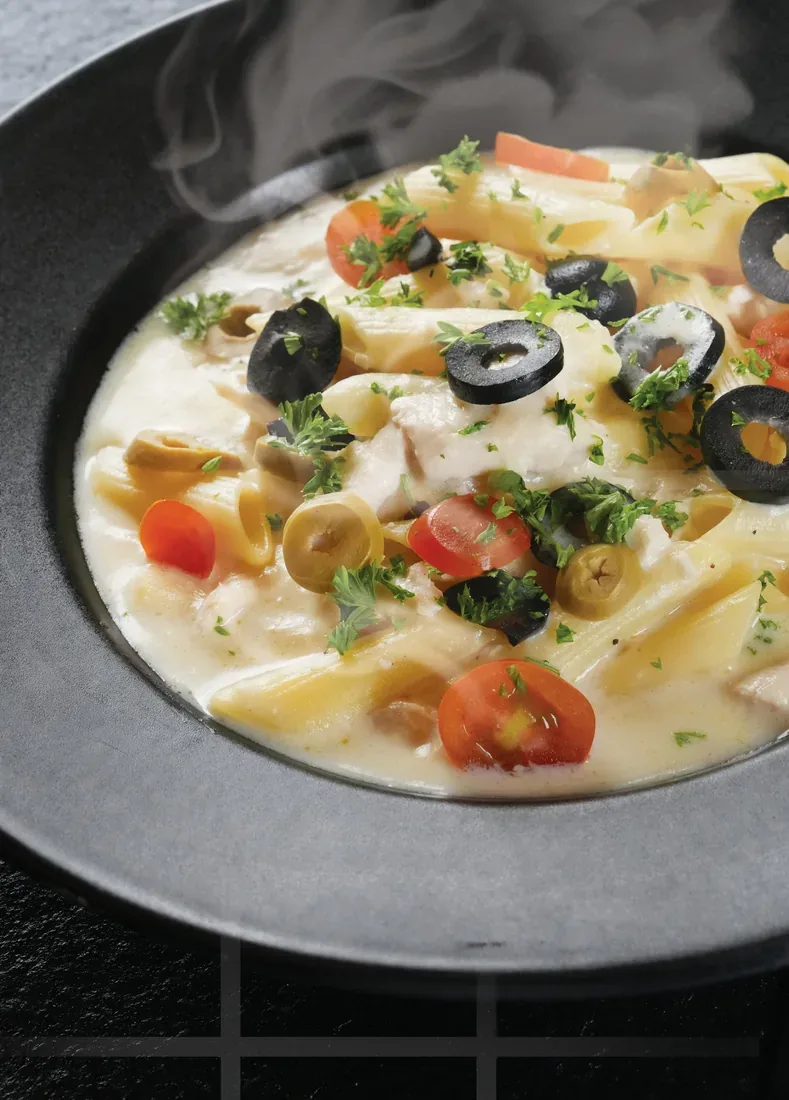 Penne in white sauce with black olives and tomatoes — Dubai food photography