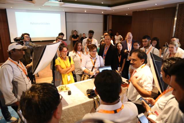 Seminar attendees photographing a plated dish with their phones